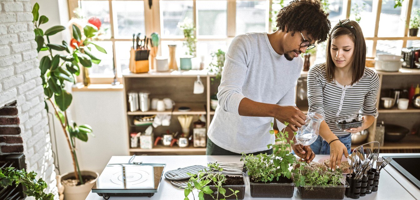 Couple Gardening In Kitchen